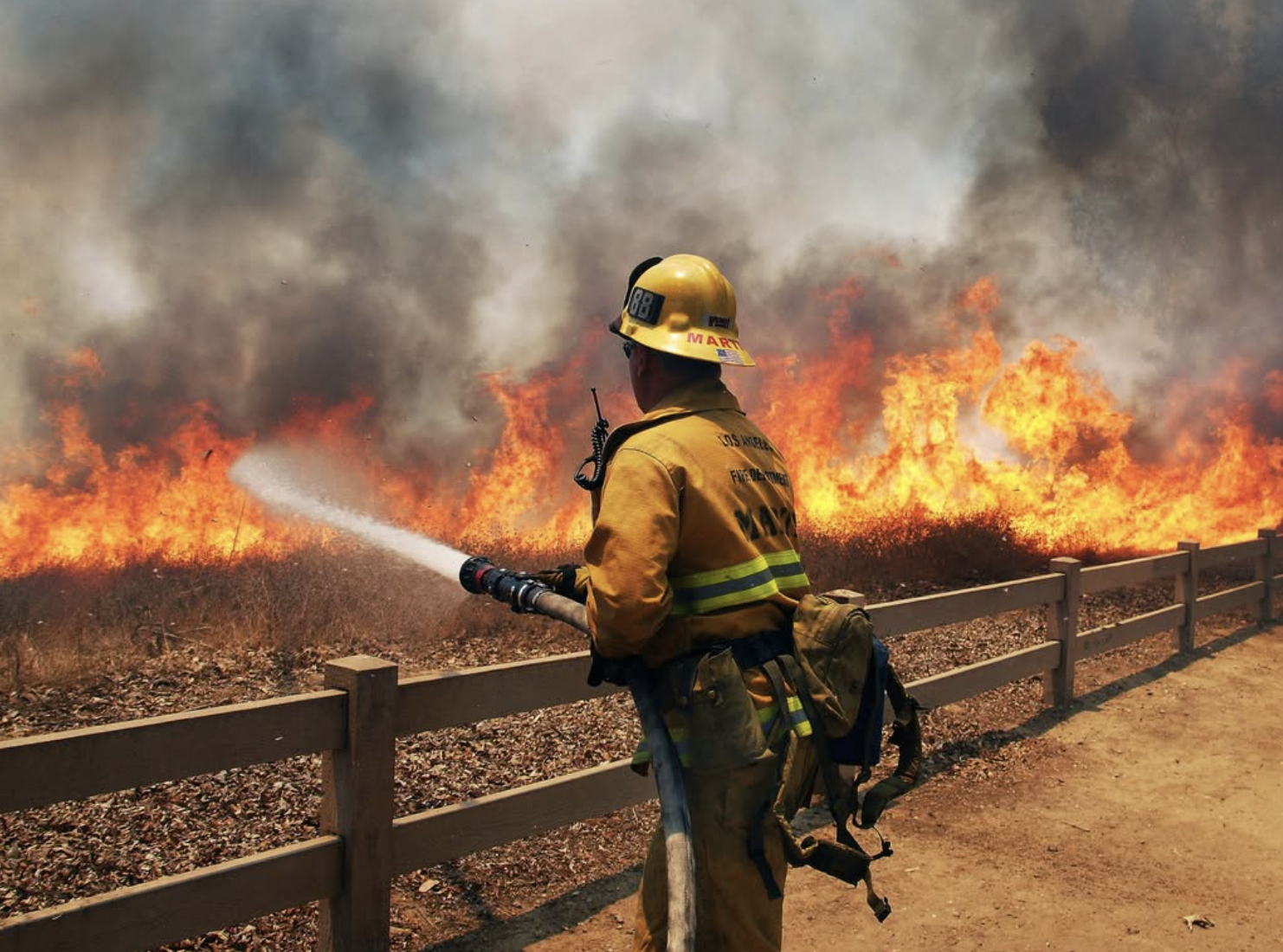 LA firemen with fire in background